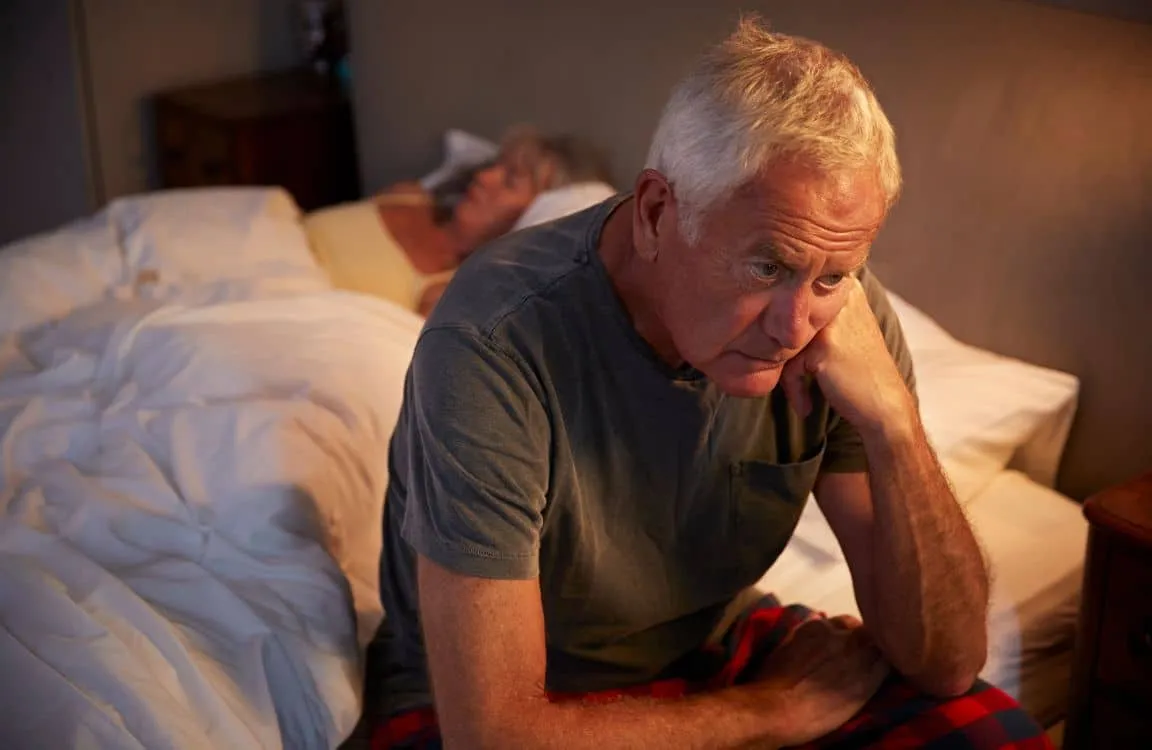 male sitting on edge of bed nocturia