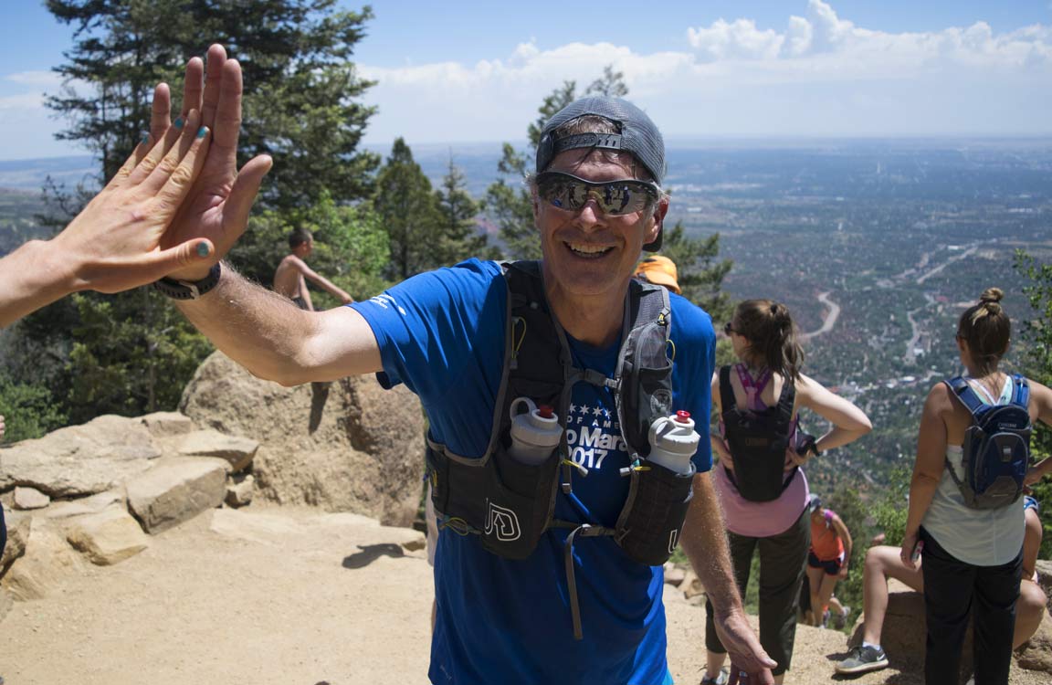 runner high five top of incline