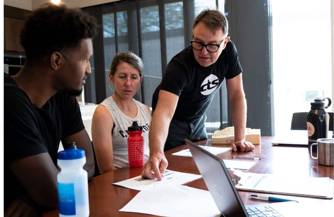 The Benefits Of Working With A Cycling Coach 2 Cycling coach reviewing data with cyclist