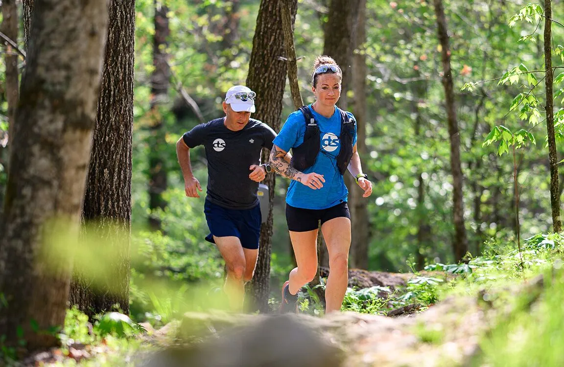 trail runners in the woods
