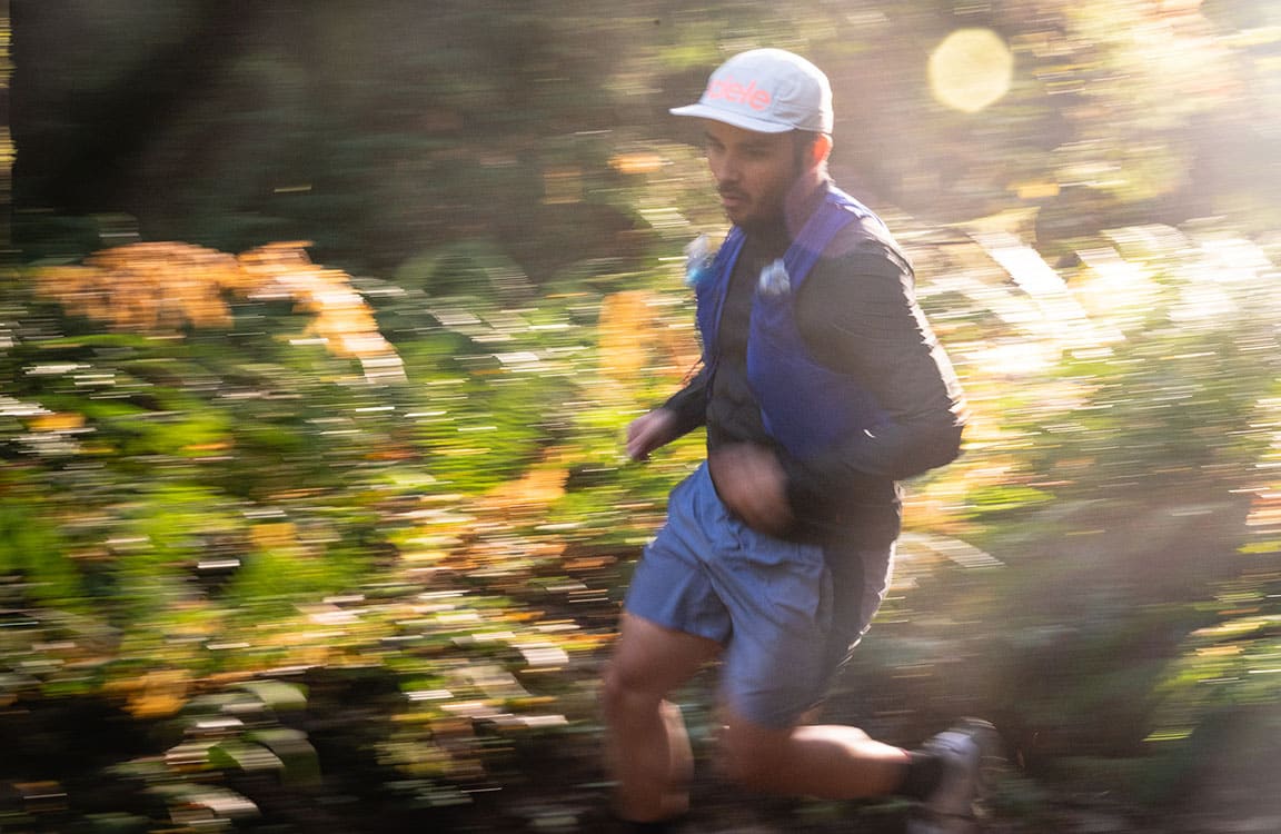 male runner in forest blurred