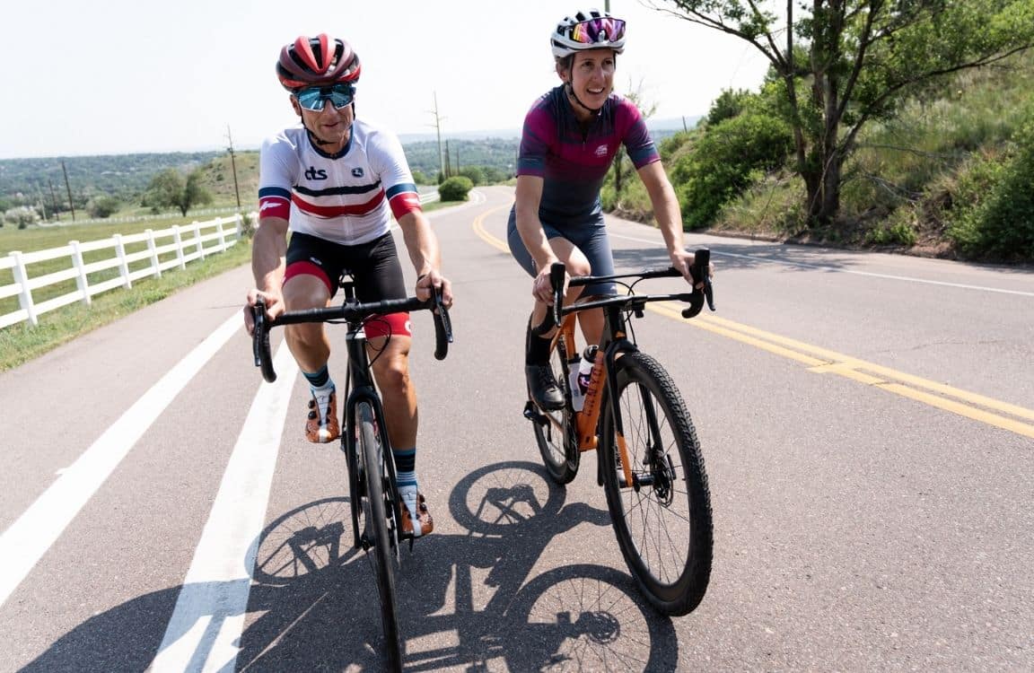 Cycling coach riding with athlete