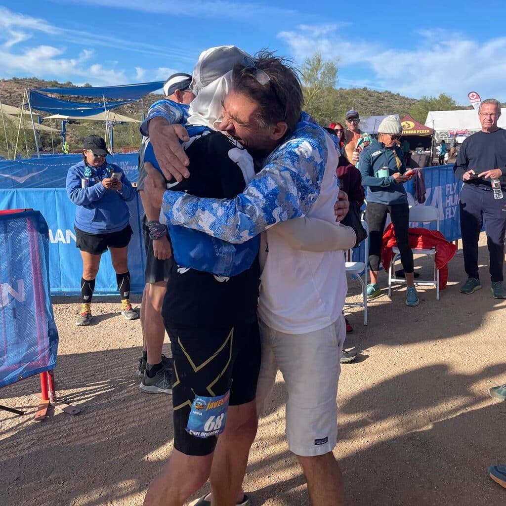 Henry Bickerstaff and Coach Andy Jones-Wilkins hug after race finish