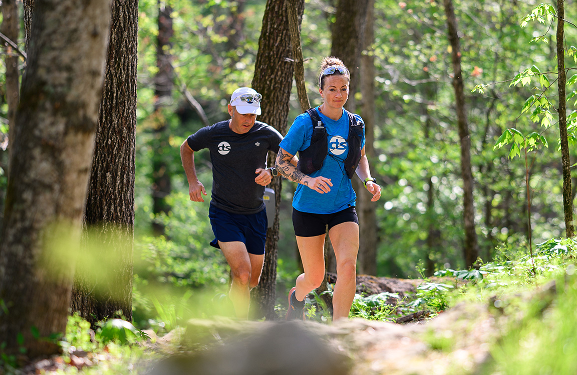 trail runners in the woods