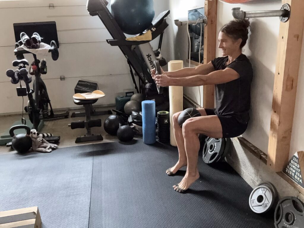 Wall sit heels elevated ball squeeze plate hold ISO sized